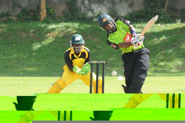 Uganda Select skipper Brian Masaba (R) lashes out in his unbeaten knock of 40 off 65 as Uganda XI wicket-keeper Lawrence Ssematimba looks on at Kyambogo Oval yesterday. PHOTO BY EDDIE CHICCO 