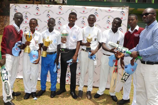 Justine Ligyalingi, the UCA CEO hands equipment to captains of teams set to participate in the Schools Cricket Week. PHOTO BY Eddie Chicco 