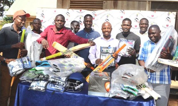 Full Protection. UCA Operations Manager Martin Ondeko (C) and Development Manager Henry Okecho (2nd R) pose with some of the teachers after giving them kits. Photo by EDDIE CHICCO 