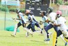 The Lady Cricket Cranes practice running between the wickets at Lugogo Oval under the watchful eye of coach Otieno (not in pic) last week. Photo by EDDIE CHICCO 