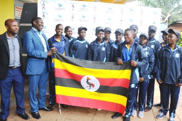 Keep The Flag Afloat. NCS’ Katende (2nd L) and Ondeko (L) saw off the young girls cricket team to Kigali yesterday. PHOTO BY EDDIE CHICCO 