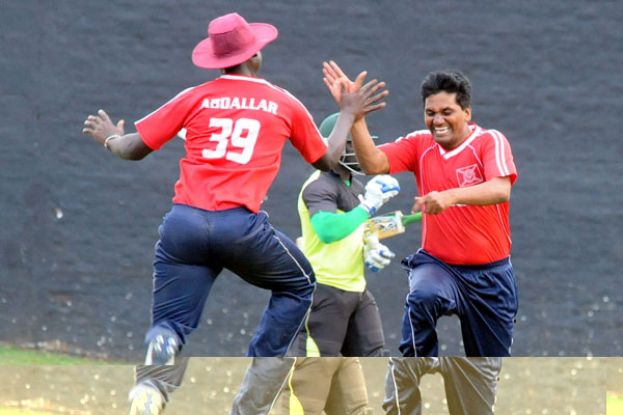 KICC captain Hanumant Katkar (R) and batting all-rounder Abdallah Lubega celebrate a fall of a wicket. PHOTO BY EDDIE CHICCO 